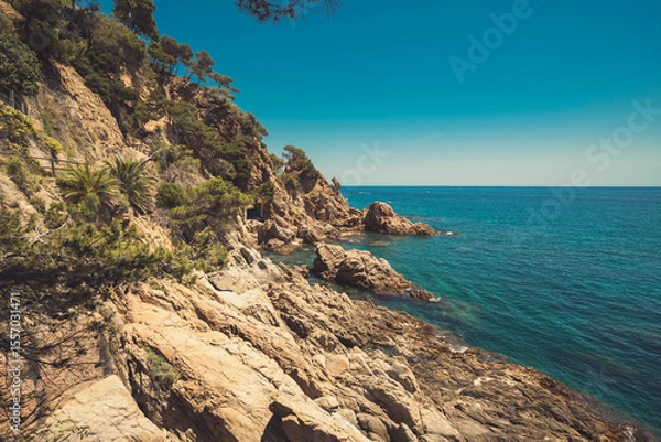 Fototapeta View of rocky cliffs jutting into the Mediterranean Sea in Blanes, Costa Brava, Spain.