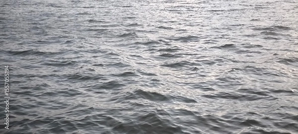 Obraz Water waves and evening light for background