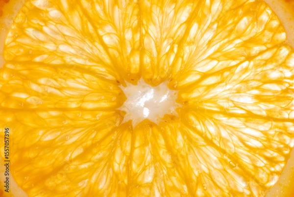 Obraz The photograph shows the surface details of a halved orange, studio light from behind.