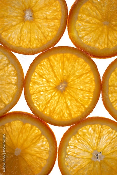 Obraz The photograph shows the surface details of a halved orange, studio light from behind.