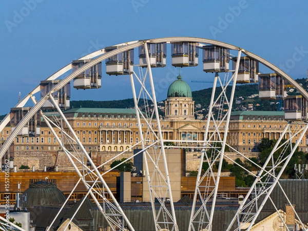 Fototapeta The Giant ferris wheel is framing the Buda royal castle. Hungarian name is Budai var.
