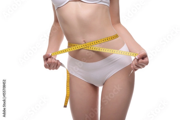 Fototapeta woman measuring waist on blue background