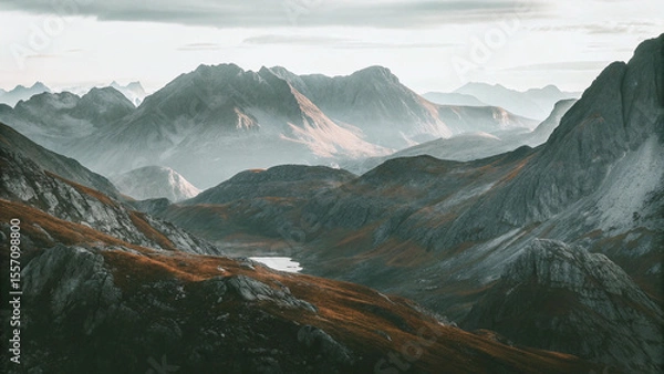 Fototapeta Majestic Mountain Landscape with Serene Lake and Hazy Sunlight