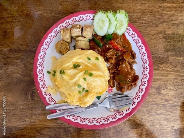 Fototapeta Thai Beef curry (Panaeng neua) serving with omlette,  deep fried chicken rolls and rice. Thai food. Selective focus, top view