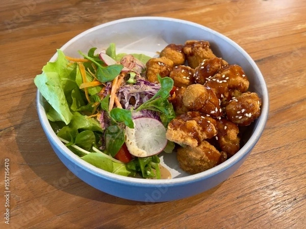 Fototapeta Crunchy chicken popcorn dressing with sweet teriyaki sauce and served with fresh vegetables, selective focus