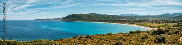 Fototapeta Panoramic view of the white sand beach at Lozari in the Balagne region of the Mediterranean island of Corsica with the Desert des Agriates in the distance