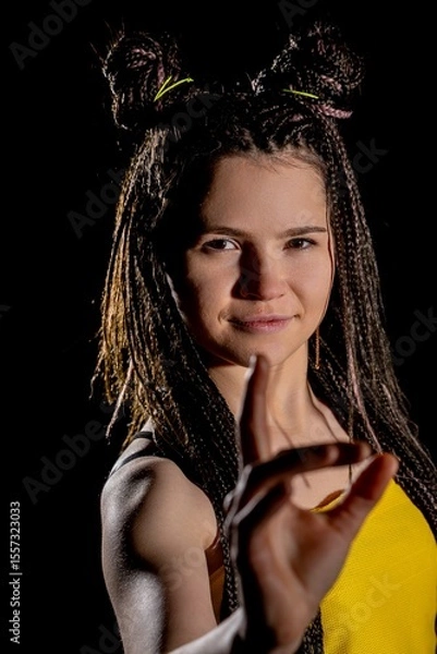 Obraz A youthful woman wearing yellow with a playful expression that exudes joy and liveliness