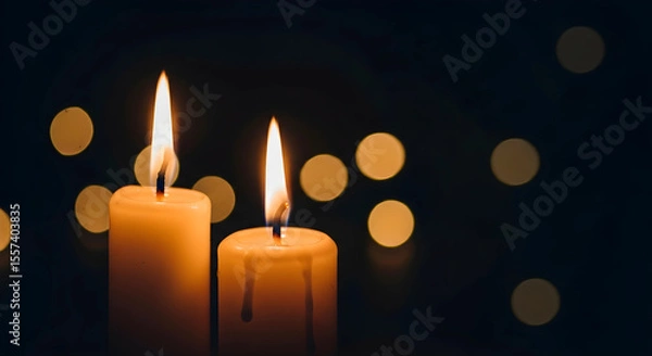 Obraz Two burning candles in dark background