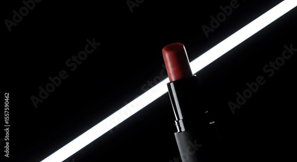Obraz Elegant lipstick in a black tube showcased against a stark, modern backdrop with a sleek, glowing light.