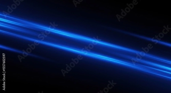 Fototapeta Dynamic blue light streaks across a dark background, creating an abstract, energetic visual effect.