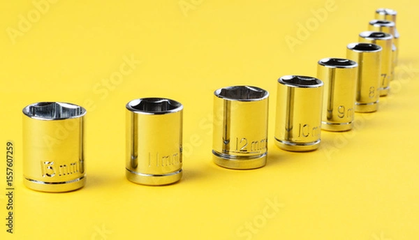 Fototapeta Hexagonal socket wrench attachments set 13mm and smaller on yellow background