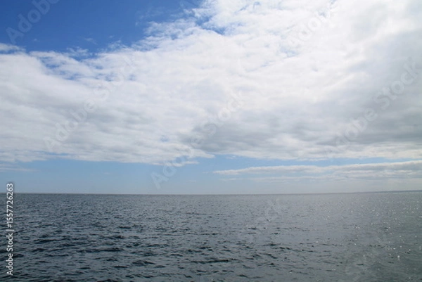 Obraz A Seascape of Sky Clouds Over an Open Ocean Sea.