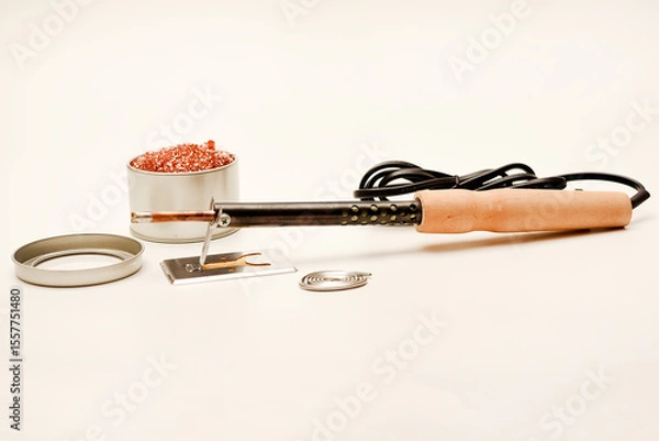 Fototapeta A soldering iron with a wooden handle with solder and a stand. Soldering iron and stinger cleaner.