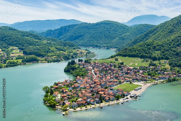 Fototapeta The small town of Divic in Bosnia on the bank of the Drina River, surrounded by the Balkan Mountains