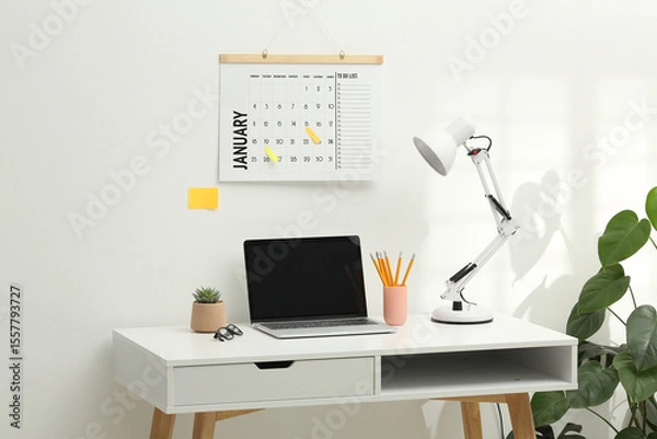 Fototapeta Desktop calendar on a modern desktop. Schedule and time planning in office and business.