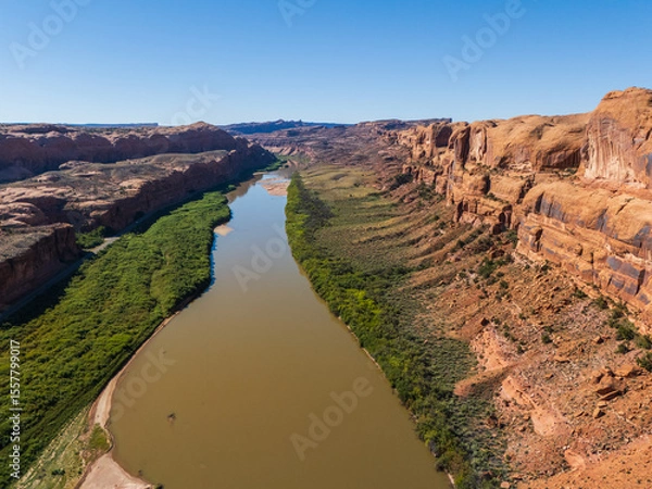 Obraz Beautiful Colorado River Through Red Desert Landscape With Towering Sandstone Canyon in Moab Utah