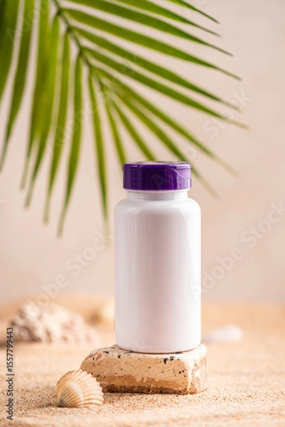 Fototapeta Bottle with capsules of the supplements vitamin d on the background of the sunny beach with sand in a white plastic jar. Vitamin D, fish oil. Healthy eating concept. High quality photo