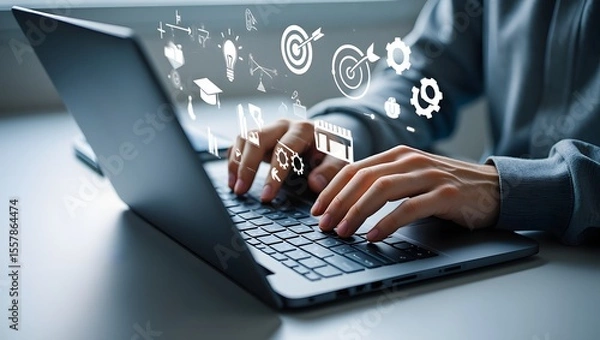 Fototapeta Online education and digital learning concept. Hands typing on a laptop with education icons such as diploma, brain, and target, ideal for e-learning platforms, digital skill development.