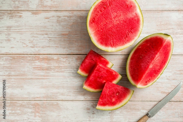 Fototapeta Slices of fresh watermelon on bright rustic wooden table, copy space