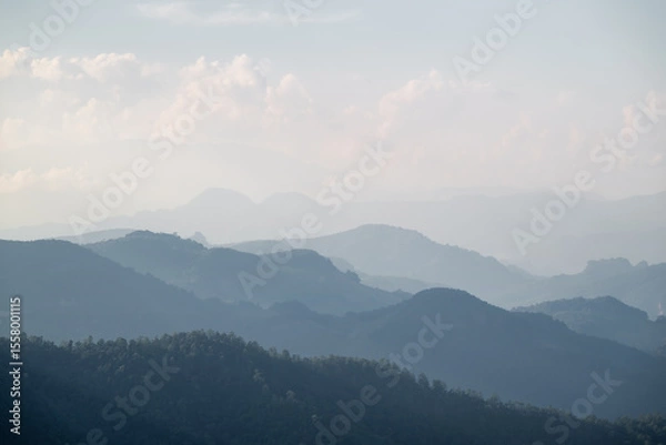 Fototapeta Layered mountain landscape in morning mist, Scenic fog landscape of mountain ridges, Tranquil natural scene with blue mountain layers, Misty morning in remote highlands