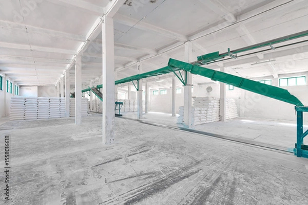 Fototapeta Flour sack storage facility features conveyor system and organized stacks for efficient grain management