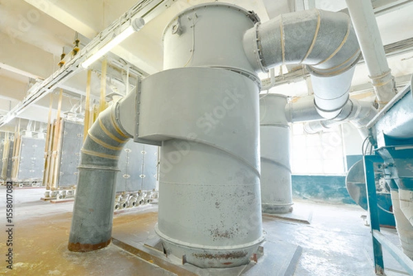Fototapeta Industrial ventilation system in a manufacturing facility highlighting large ductwork and machinery