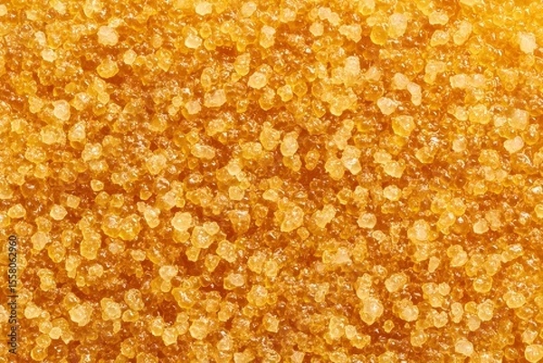Obraz A close-up macro shot of coarse brown sugar, perfect for culinary, food, or texture-related projects. The granular details and golden color evoke warmth and deliciousness.