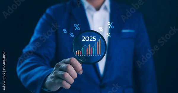 Fototapeta Business Growth and Financial Forecast 2025 Concept. A person uses a magnifying to examine economic data and trends for the year 2025, percentage symbols, market analysis and strategic planning.