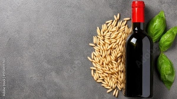 Fototapeta Red Wine Bottle with Pasta and Basil on Gray Background