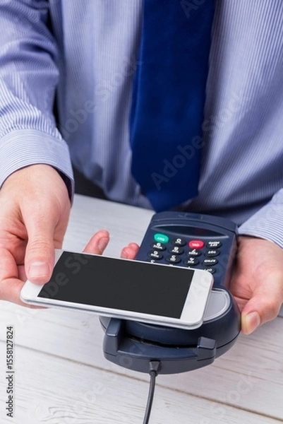 Obraz Man using smartphone to express pay