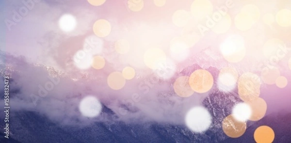Fototapeta Snow covered mountains with bokeh in foreground