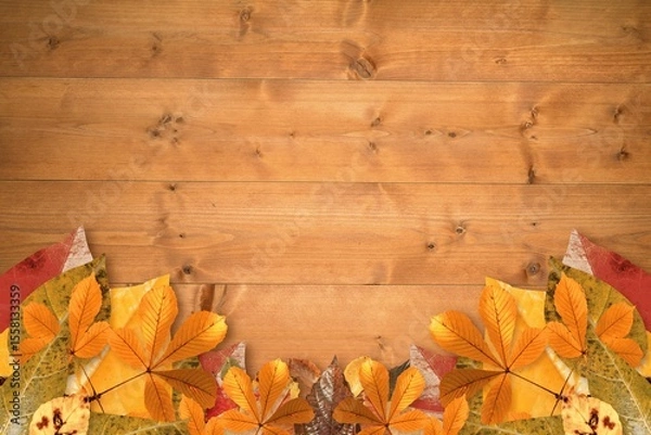 Fototapeta Rustic flat design is showing wooden plank surface with fallen autumn leaves border, copy space