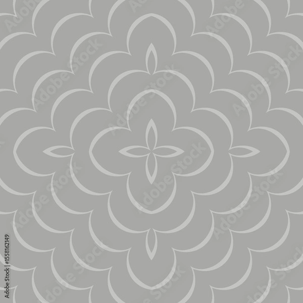 Fototapeta A symmetrical floral pattern with an intricate design, featuring repeating petal shapes and a central flower-like motif in a monochromatic gray tone. 