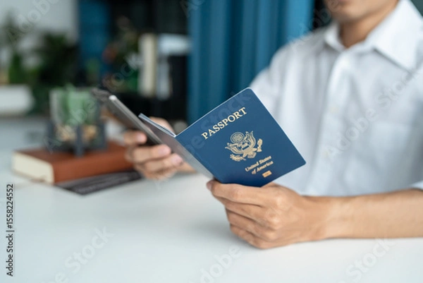 Fototapeta Hand Man Online booking and buying plane tickets using laptop phone and credit card Planning trip travel vacation with passport and ticket.