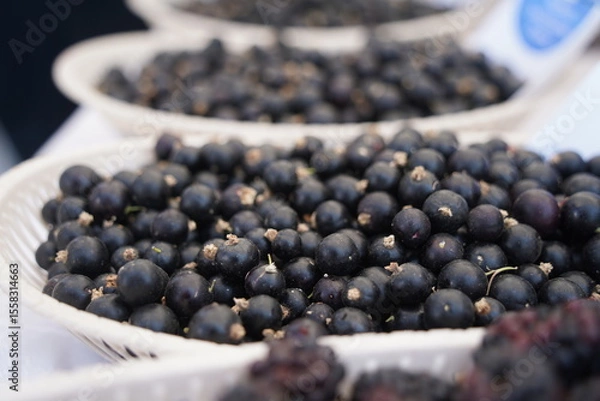 Fototapeta Berries on a large plate on the table. Summer harvest.