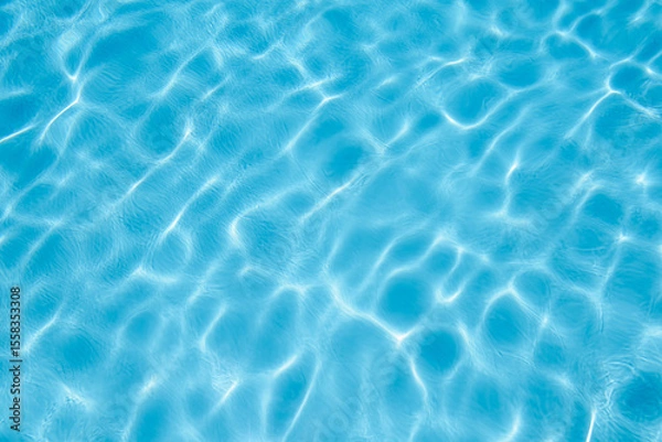 Obraz Blue surface of swimming pool water reflecting light caustic pattern.
