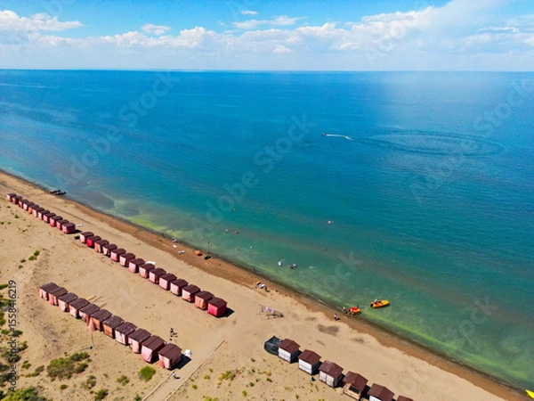 Fototapeta Beach houses on the shore of Lake Balkhash. Summer vacation. The view from the drone.