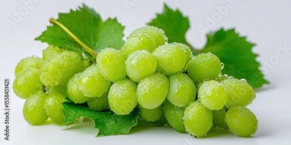 Fototapeta The cluster of fresh green grapes with water droplets and leaves