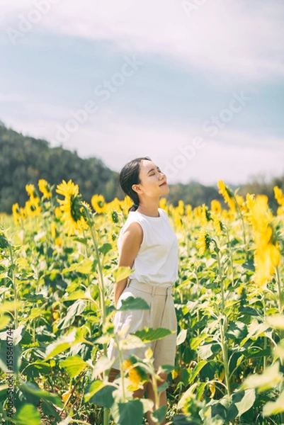 Obraz Solitude and freedom woman standing relax in sunflower botanical field park outdoors with sunlight