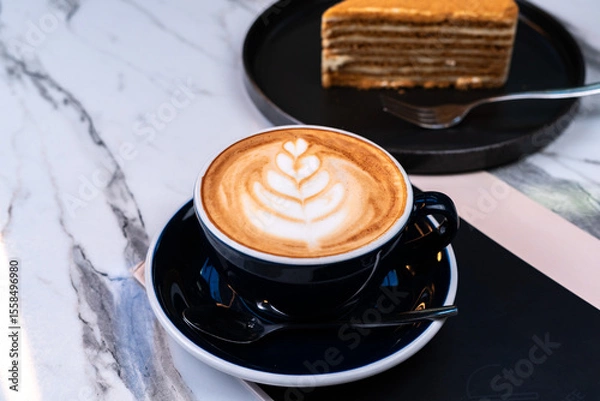 Fototapeta Latte coffee with honey cake and blurred background