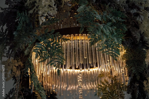 Obraz Elegant chandelier adorned with greenery creates an enchanting atmosphere in a modern space