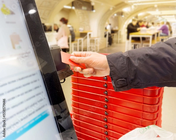 Obraz Self-checkouts or self-service checkouts,man paying for the purchases  in supermarkets
