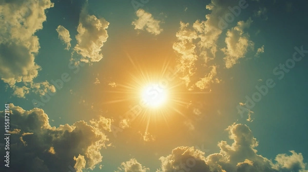 Fototapeta The sun shines brightly through the clouds in the sky above the clouds in the sky, and the sun shines brightly through the clouds in the clouds in the sky