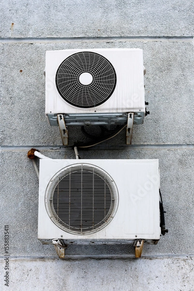 Obraz Two Old Air Conditioners Mounted on an Exterior Wall, Showcasing Urban Decay and Vintage Design.