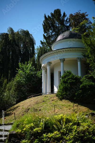 Fototapeta This is a tranquil and picturesque park featuring a beautiful gazebo.