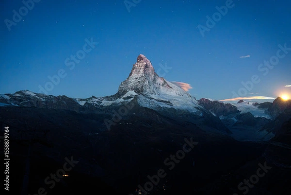 Fototapeta Matterhorn mountain with moonlight glowing in the dusk at Switzerland