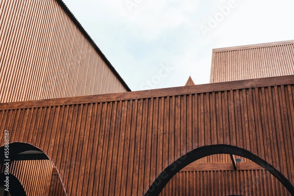 Fototapeta Modern architecture with vertical coated wood metal steel and geometric design