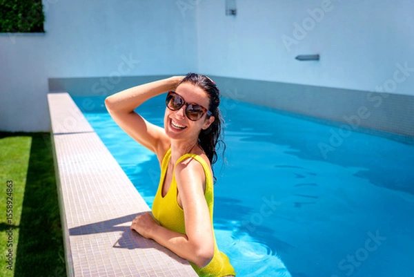 Obraz Woman in yellow swimsuit swimming in the pool on a summer day
