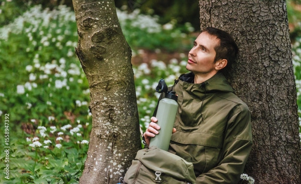 Obraz Man Walking through Blooming Forest Glade