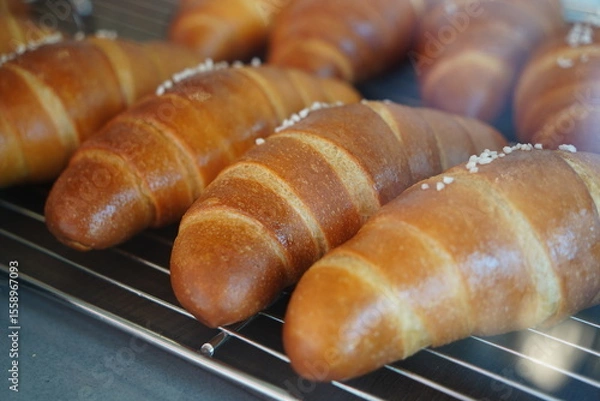 Obraz Close-Up of Freshly Baked Salt Butter Rolls with Crusty Surface and Sea Salt on Top